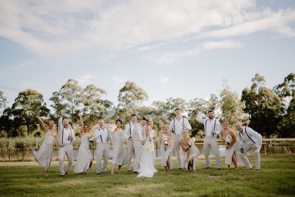 A wedding party celebrating together on the lawn at Rochford